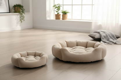 Two beige pet beds on a light wooden floor with a neutral background